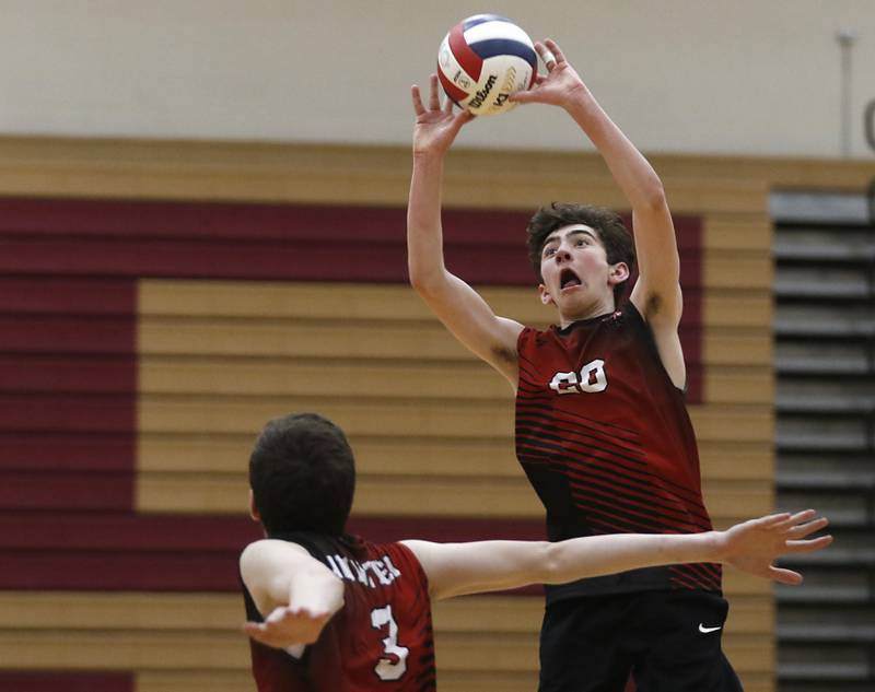 Huntley's Matthew Leith sets the ball for his teammate, Josh Iddings, during a nonconference boys volleyball match against St. Charles North Monday, May 8, 2023, at Huntley High School.