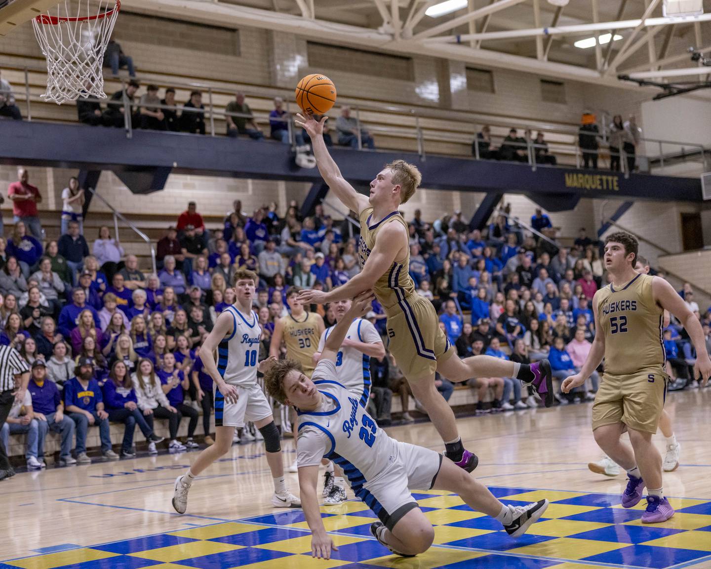 Serena's Tucker Whiteaker drives over Luke Badal of Hinckley-Big Rock during the Class 1A Regional Championship on February 28, 2025 at Bader Gym.