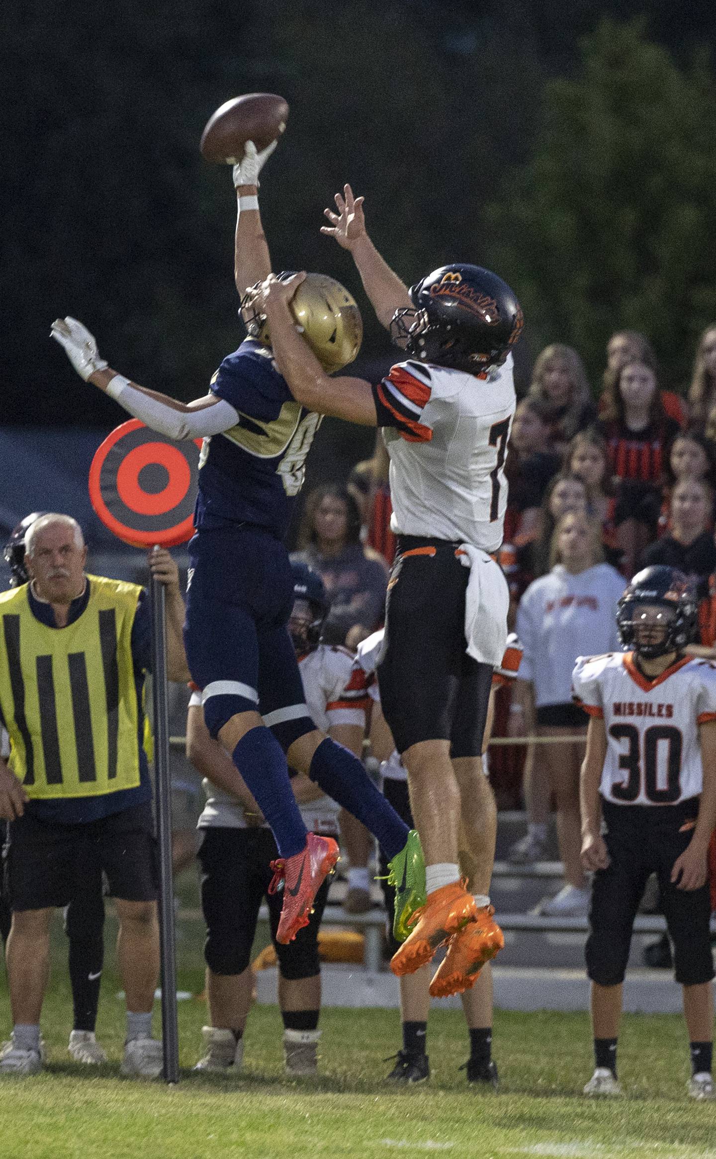 Polo’s Mercer Mumford and Milledgeville’s Konner Johnson leap for a passed ball Friday, Sept. 19, 2025.