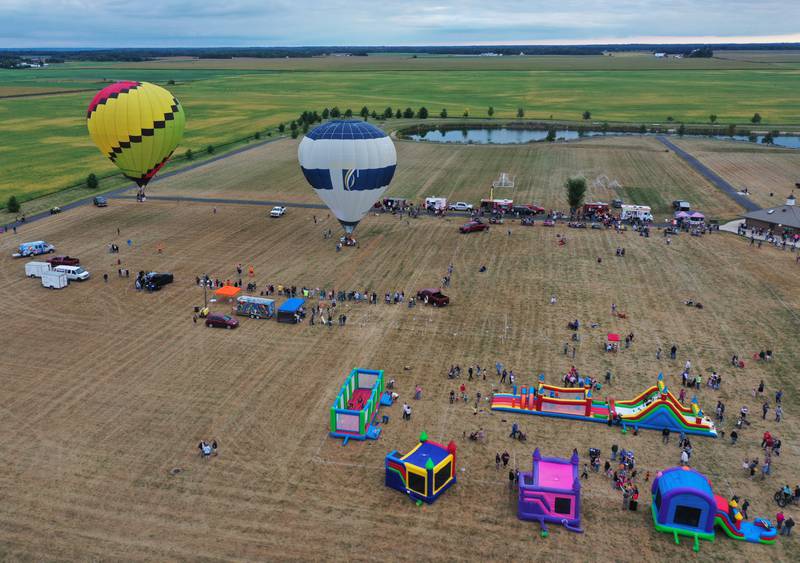 Hot air balloons fly above Zearing Park during the 52nd annual Homestead Festival on Friday, Sept. 8 2023 in Princeton.