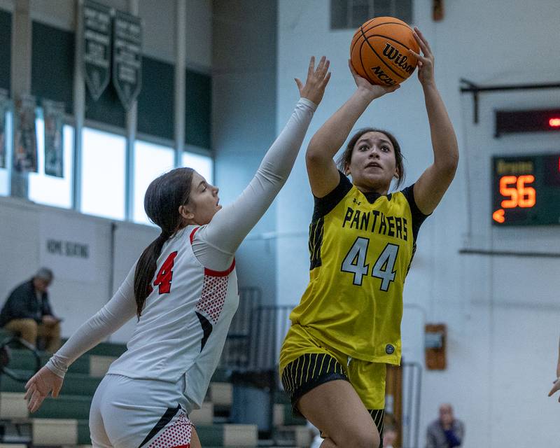 Kaylynn Hill (44) of Putnam County pulls up for midrange shot as Madison Hersemann (24) of Brimfield attempts to contest shot on Friday, December 26, 2025 at St. Bede High School in Peru.