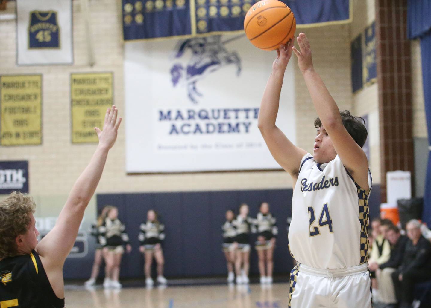 Marquette's Matt Graham lets go of a shot over Putnam County's Drew Carlson on Friday, Jan. 17, 2025 in Bader Gym at Marquette Adademy.