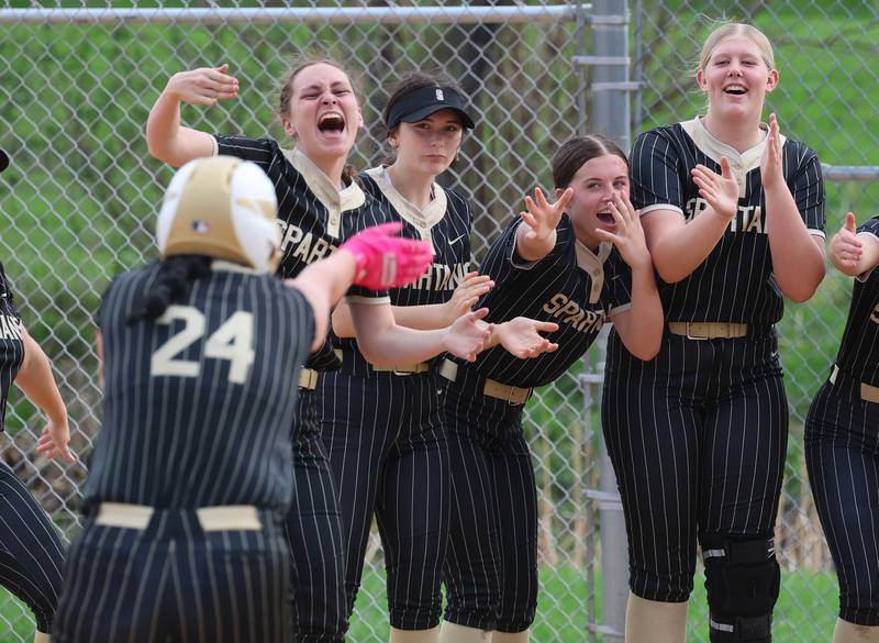 Sycamore's Kairi Lantz is greeted by her teammates after homering Friday, April 17, 2026, during thier game against Ottawa at Sycamore High School.