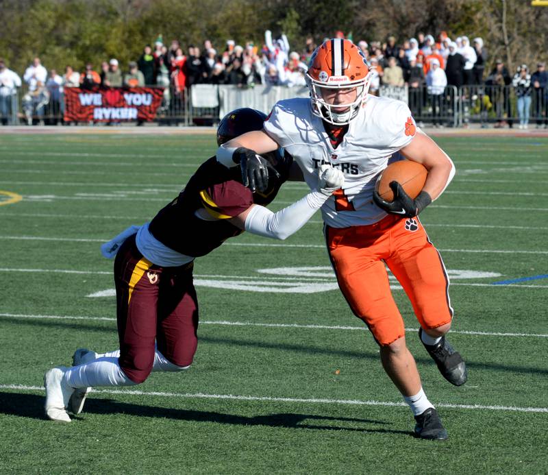 Byron's Brayden Knoll (1) fights off a Lombard-Montini defender during 3A football semifinals in Lombard on Saturday, Nov. 18, 2023.