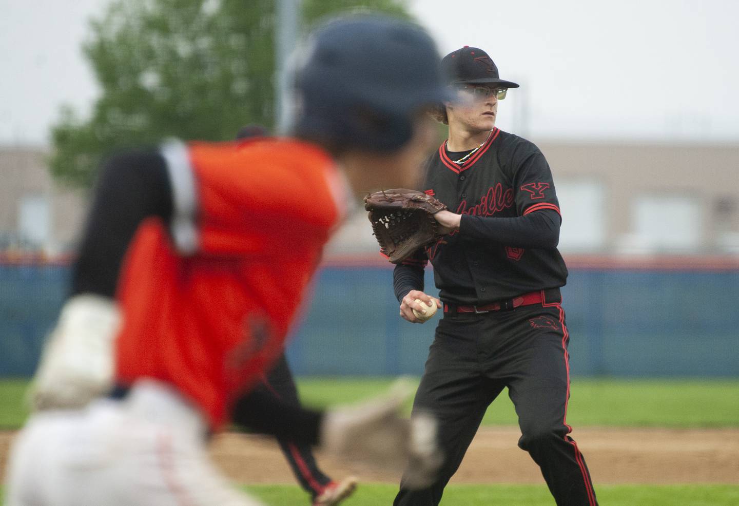 Yorkville pitcher Michael Hilker (8) takes his time throwing to first after fielding a sharply hit ball by Oswego an batter during a varsity boys baseball game on Wednesday, May 18, 2022 at Oswego High School.