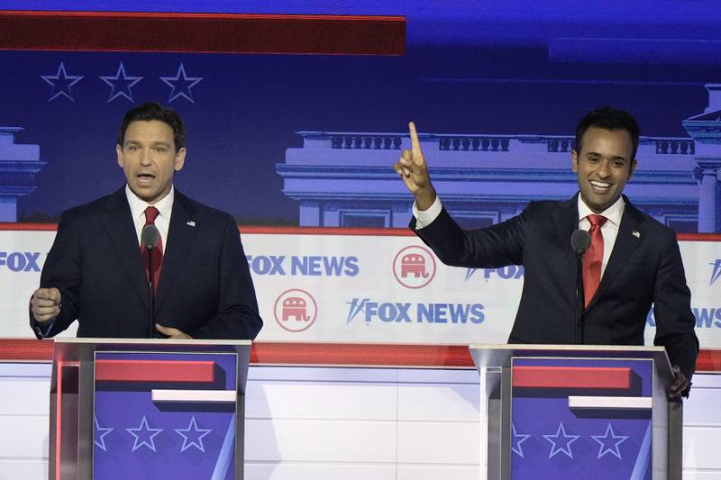 Florida Gov. Ron DeSantis and businessman Vivek Ramaswamy talk at the same time during a Republican presidential primary debate hosted by FOX News Channel Wednesday, Aug. 23, 2023, in Milwaukee. (AP Photo/Morry Gash)