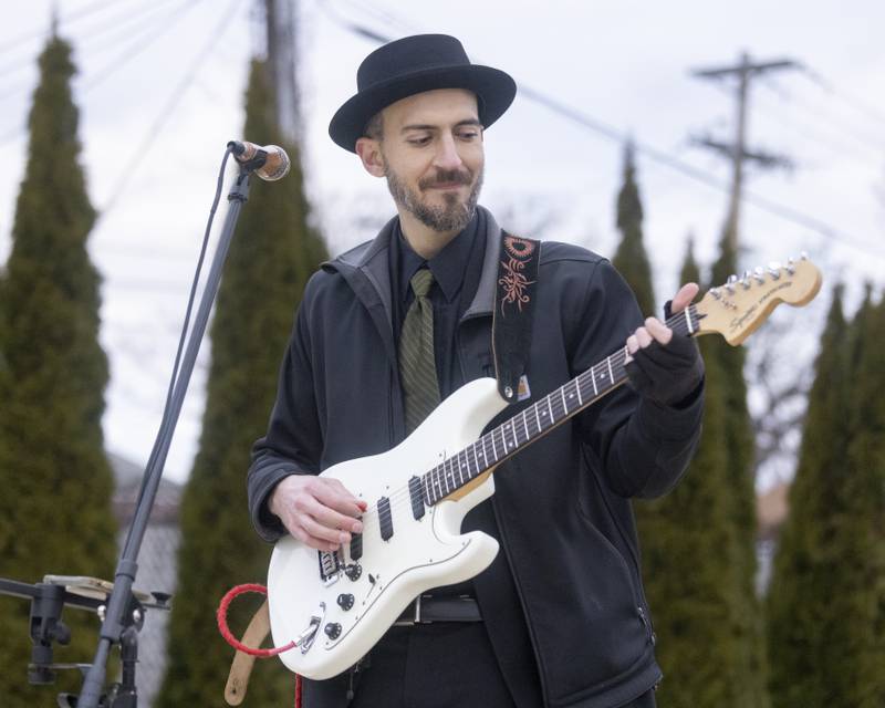 Musician Kevin Kramer plays Christmas music downtown prior to the start of the 2nd annual Oglesby Winter Parade on December 9, 2023.