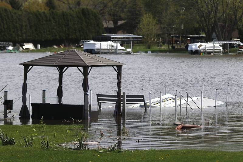 Partially submerged docks near the intersection Long Avenue and Sunnyside Beach Drive in Johnsburg on Sunday, April 19, 2026, as the Fox River continues to rise.