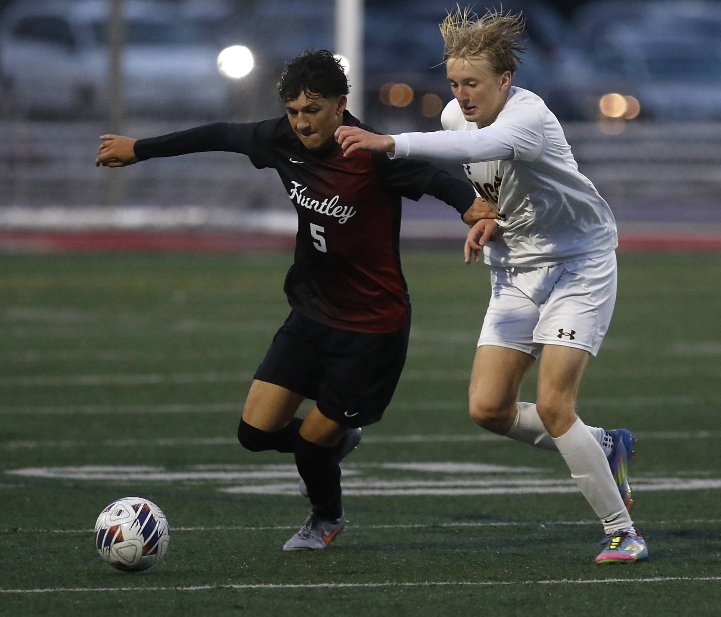 Huntley's Noah Gomez battles with Jacobs' Elijah McCloud for the ball during an IHSA Class 3A Huntley Regional boys soccer semifinal match on Tuesday, Oct. 21, 2025, at Huntley High School.