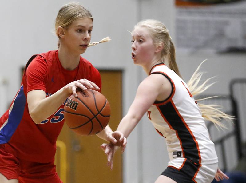 Dundee-Crown’s Monica Sierzputowski drives to the basket against on McHenry's Holly Waters during a Fox Valley Conference girls basketball game on Tuesday, Dec. 12, 2023, at McHenry High School.