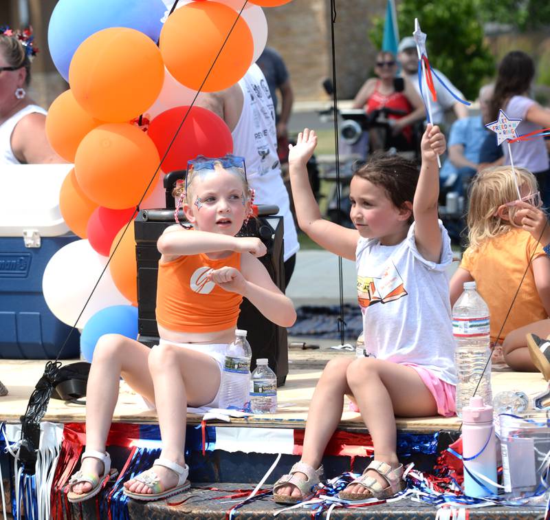 Members of the Genesis Dance Company perform while riding on their float during the Let Freedom Ring parade on Friday, July 4, 2025 in Mt. Morris.