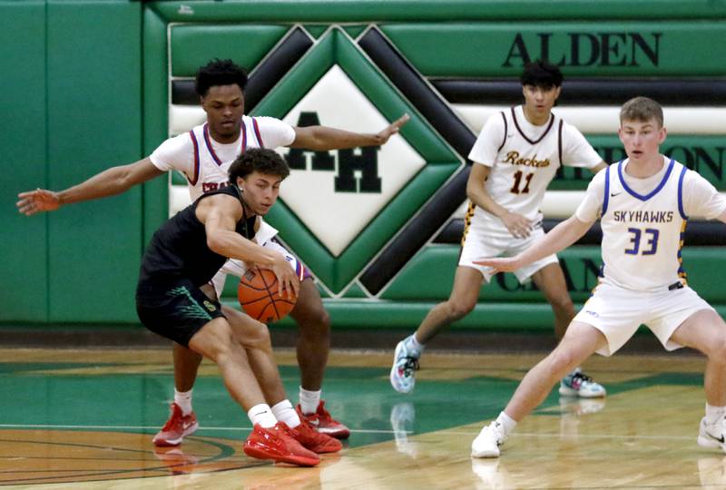 Crystal Lake South's AJ Demirov tries to spin away from the defense of Dundee-Crown’s Terrion Spencer, Richmond-Burton's Ben Roberts and Johnsburg's JT Schmitt during the boy’s game of McHenry County Area All-Star Basketball Extravaganza on Sunday, April 13, 2025, at Alden-Hebron’s Tigard Gymnasium in Hebron.