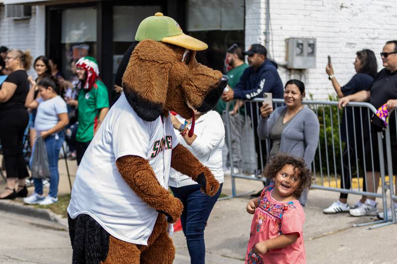 Joliet Slammers mascot Spikes has fun with Agnes Valdivia during the City of Joliet Fiestas Patrias Mexican Independence Day Parade on Sept. 13, 2025.