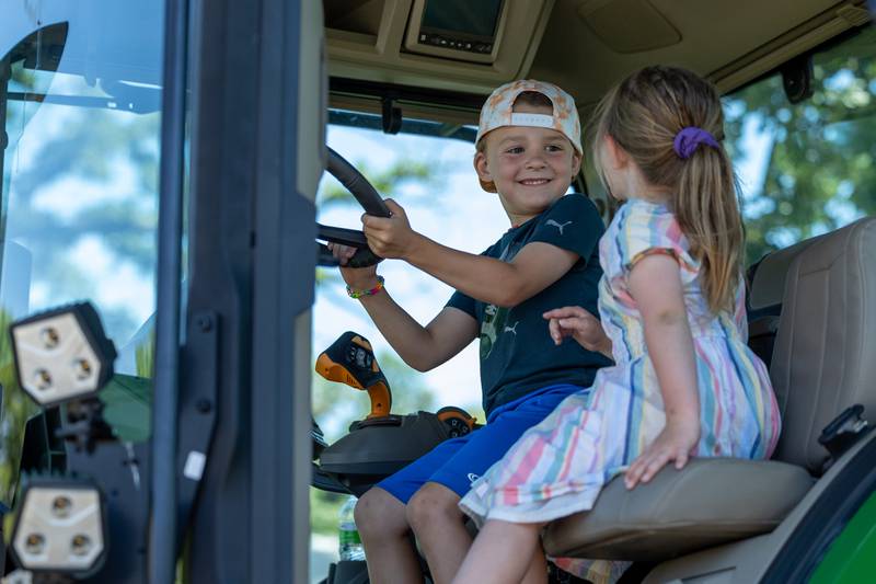 (left to right) Owen Nadolski and Cj Curtin sit inside tractor at the Touch a Truck event on Saturday, June 28, 2025 at Centennial Park in Peru.