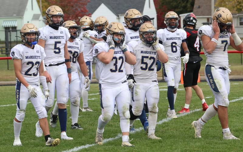 Members of the Marquette football team walk off the field after being defeated during the Class 1A playoff game on Saturday, Nov. 1, 2025 at Gibson City-Melvin-Sibley High School.