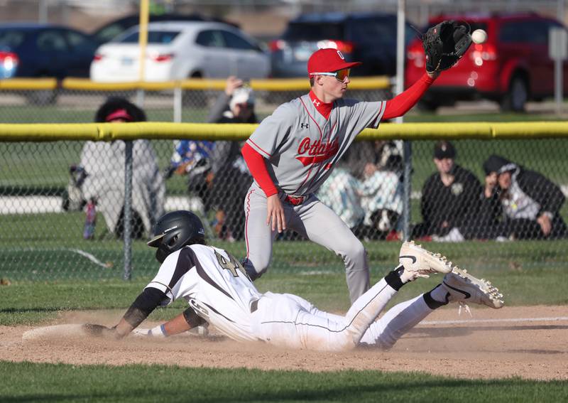 Sycamore's Tyler Townsend slides safely into third as Ottawa's Lucas Farabaugh takes the throw during their game Friday, April 19, 2024, at the Sycamore Community Sports Complex.