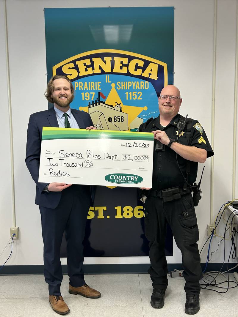 Corey Kimes with Country Financial donated $2,000 to the Seneca Police Department to new police radios.