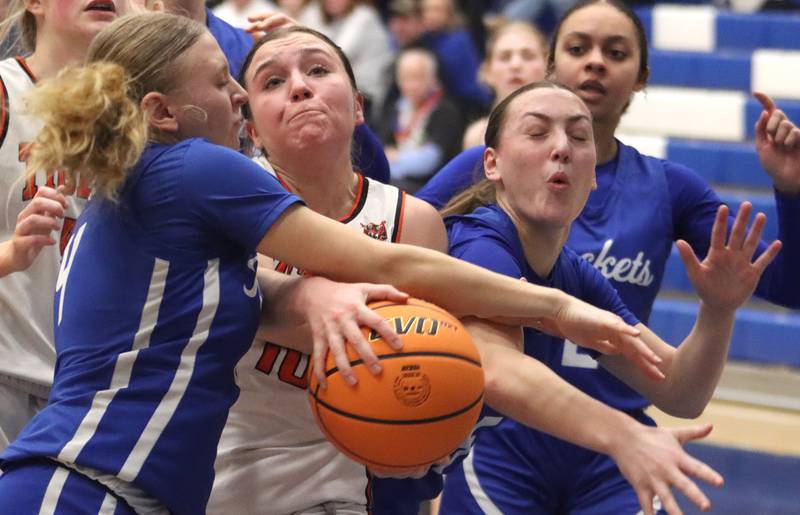 Burlington Central’s Ashley Waslo, left, and Audrey LaFleur, right, swarm Crystal Lake Central’s Sammi Pottorff in IHSA Class 3A Regional Title Game girls basketball action on Thursday, Feb. 20, 2025, at  Central High School in Burlington.