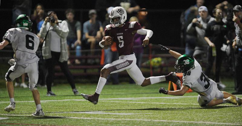 Wheaton Academy's Belay Brummel sprints downfield as St. Edward's Carson Busto and Nolan Pomeroy, right, try to stop him in a football game in West Chicago on Thursday, October 7, 2021.