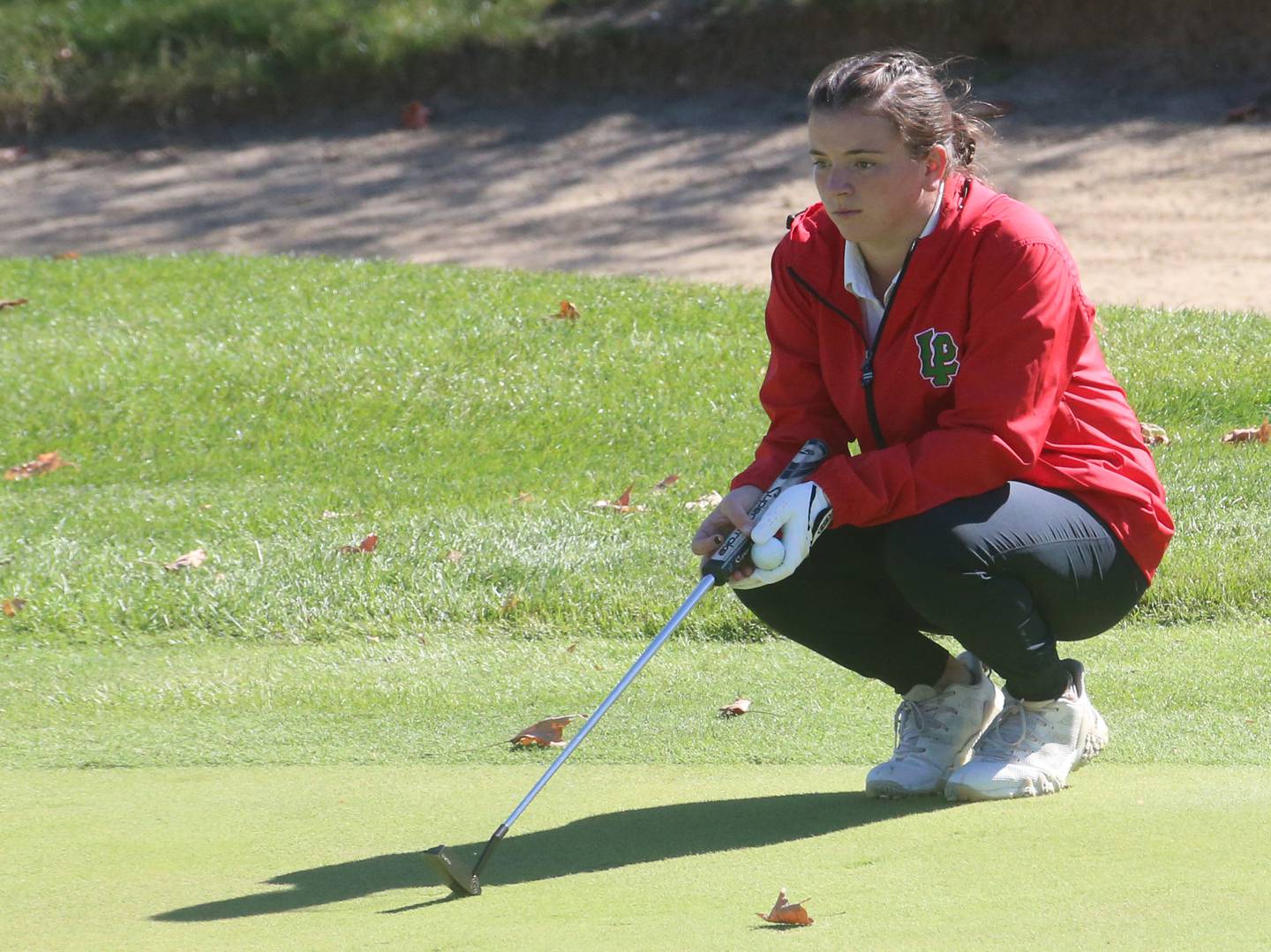 L-P's Allie Thome lines up a put during the Class 2A Regional girls golf meet on Tuesday, Oct. 1, 2024 at Senica's Oak Ridge Golf Club in La Salle.