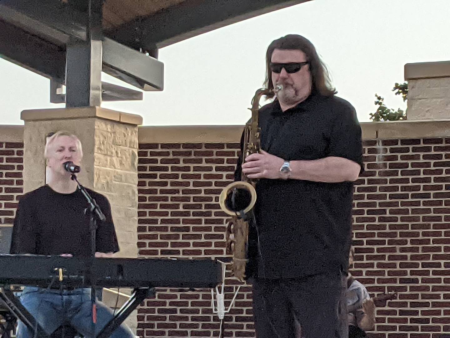 Billy Elton lead singer and pianist Reid Spears, left, and saxophonist Paul Maslin, right, perform Oct. 12 at the Pouring For Pink: Breast Cancer Benefit Concert at Venue 1012 in Oswego.