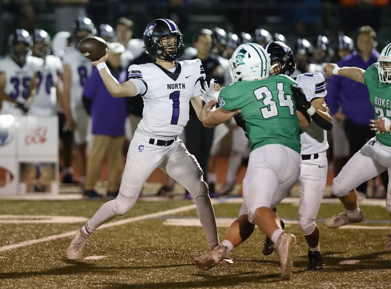 Downers Grove North's Owen Lansu (1) looks for a receiver during the varsity football game between Downers Grove North and York on Friday, Oct. 4, 2024 in Elmhurst.