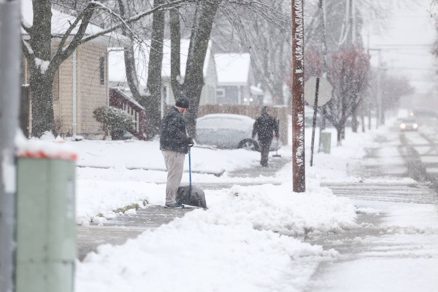 Residents along Vernon Avenue in Joliet come out to deal with the evening snow on Tuesday, Jan. 9th, 2024.