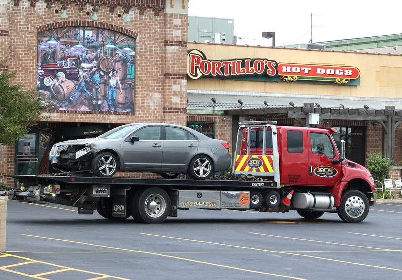 The car that crashed into a Portillo’s Wednesday, July 30, 2025, is removed from the front entrance of the business at 2810 U.S. Route 34 in Oswego injuring 12.