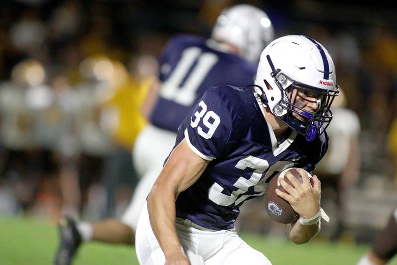 Cary-Grove’s Holden Boone runs the ball against Jacobs in varsity football on Friday, Sept. 20, 2024, at Al Bohrer Field on the campus of Cary-Grove High School in Cary.