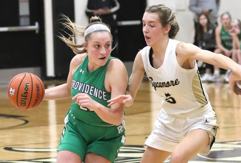 Providence Catholic's Annalise Pietrzyk tries to get through the defense of Sycamore's Faith Feuerbach during their game Tuesday, Feb. 22, 2022, in the Class 3A Kaneland sectional in Maple Park.