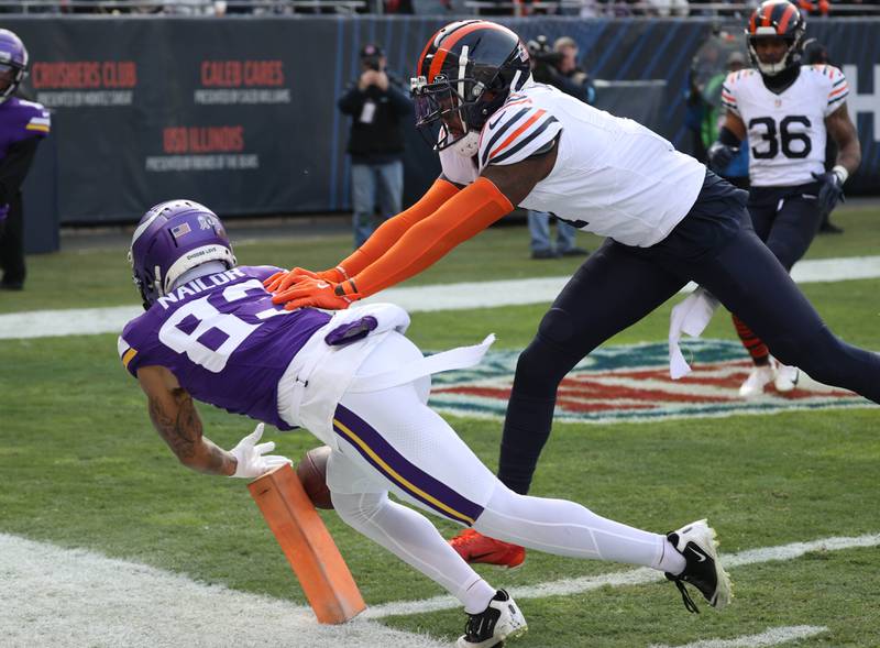 Minnesota Vikings wide receiver Jalen Nailor scores a touchdown just as he is pushed out of bounds by Chicago Bears cornerback Jaylon Johnson during their game Sunday, Nov. 24, 2024, at Soldier Field in Chicago.