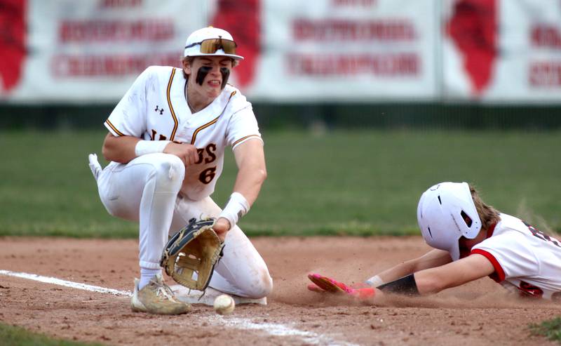 Huntley’s Kyle Larson, right, arrives safely at third base with a steal as Jacobs’ Owen Ziaja fields the throw in varsity baseball Wednesday at Huntley.