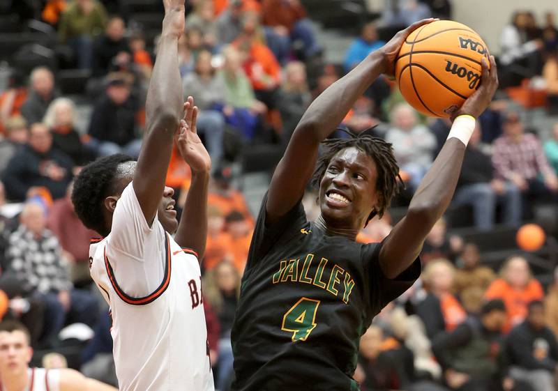 Waubonsie Valley's Moses Wilson goes to the basket against DeKalb's Marquise Bolden during their game Friday, Feb. 21, 2025, at DeKalb High School.