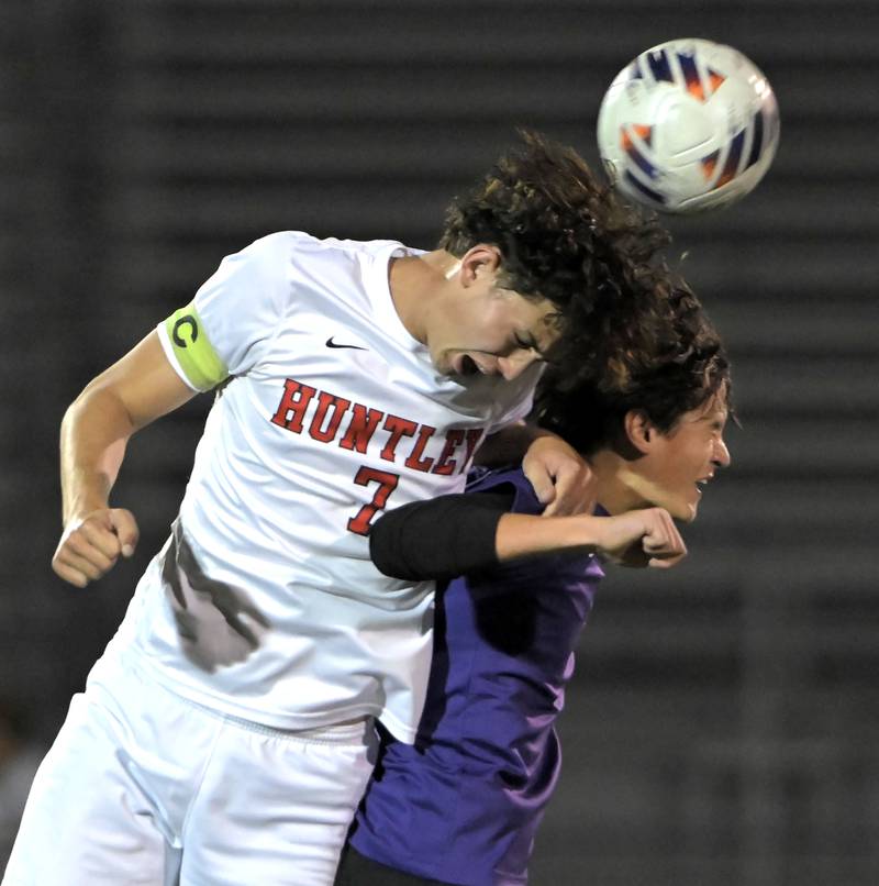 Hampshire’s Matthew Perez and Huntley’s Mason Leslie collide as they compete for a header in an IHSA Class 3A boys soccer sectional semifinal game in Streamwood on Oct. 30, 2024.