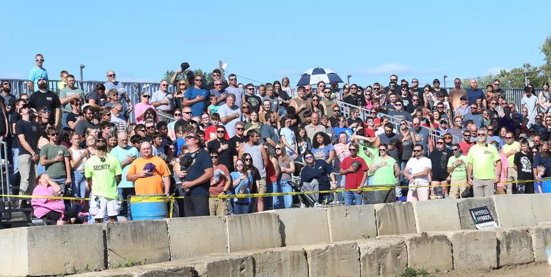 A large crowd stands for the National Anthem before the Demolition Derby during the 170th annual Bureau County Fair on Saturday, Aug. 23, 2025 in Princeton.