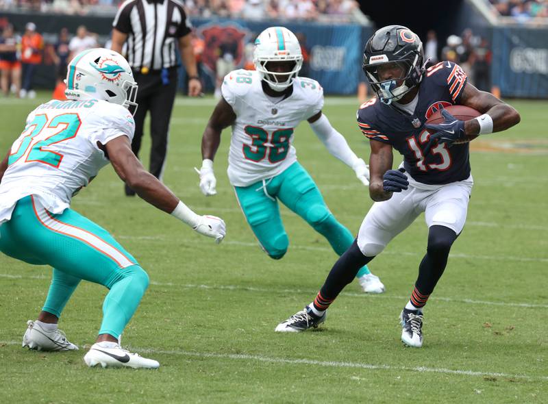 Chicago Bears wide receiver Maurice Alexander looks to avoid two Miami Dolphin defenders Sunday, Aug. 10, 2025, during their game at Soldier Field in Chicago.