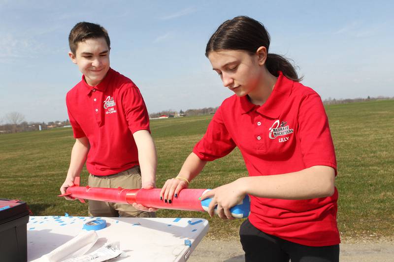 Luka Weideman, of Lindenhurst and Lilly Abney, of Round Lake Beach, both 14, with the Prince of Peace Redhawk Rocketeers Tarc Team, work on putting together their rocket to test launch it before they go to compete in the upcoming American Rocketry Challenge at the Tim Osmond Sports Complex in Antioch. The finals are held next month in Washington, D.C. on May 14th.