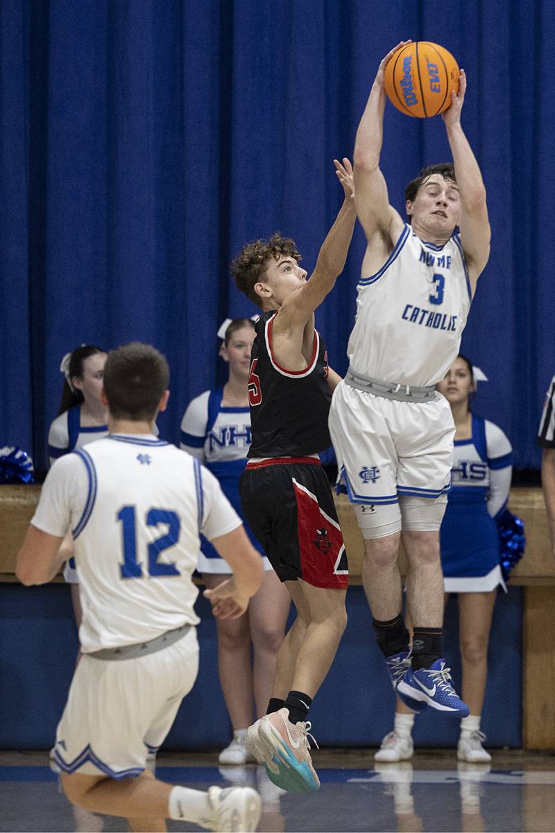 Newman’s Garret Matznick steals pass against Hall Tuesday, Feb. 17, 2026.