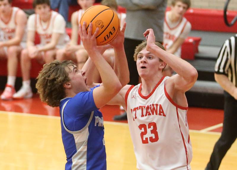 Princeton's Jayden Fulkerson eyes the hoop as Ottawa's Owen Sanders defends on Monday, Feb. 3, 2025 in Kingman Gymnasium at Ottawa High School.