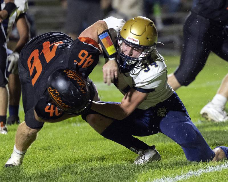 Milledgeville’s Spencer Nye is hit hard by Polo’s Gage Zeigler Friday, Oct. 4, 2024, at Milledgeville High School.