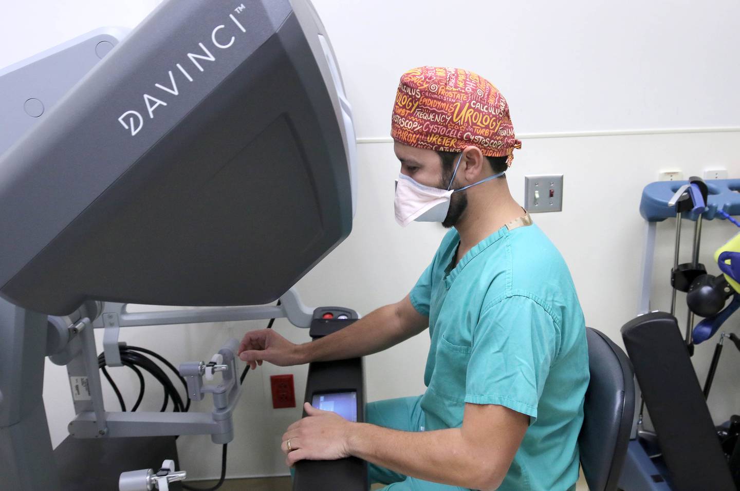 Dr. Ricardo Soares, who specializes in urologic oncology and endourology at Northwestern Medicine Kishwaukee Hospital, sits at the controls of a newly acquired surgical robot Tuesday, Oct. 18, 2022, at the hospital in DeKalb. The robot, which can be used for a variety of surgical procedures, will be put into use for the first time at the hospital this week.