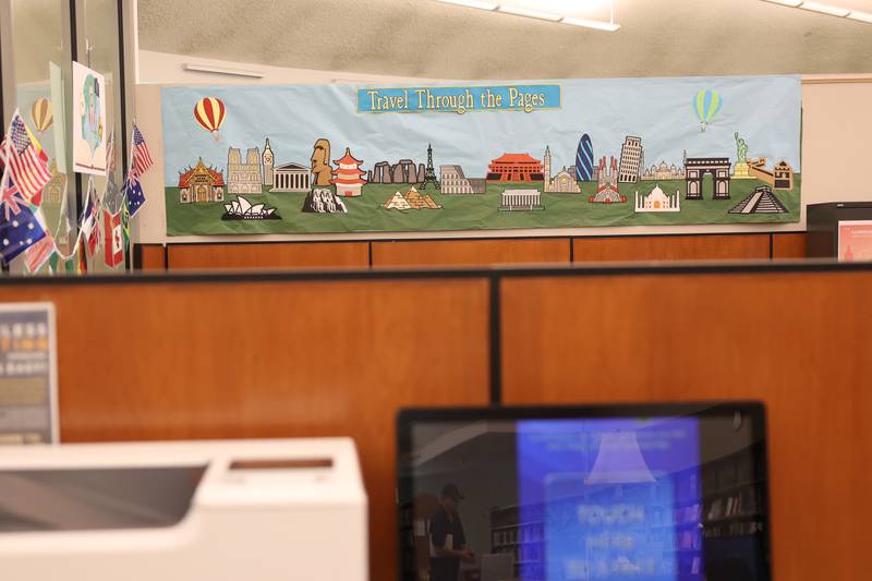 A mural painted by Laura Harper hangs in the Joliet Public Library Black Road Branch for their Travel Through the Pages summer reading program on Thursday May 30, 2024 in Joliet.