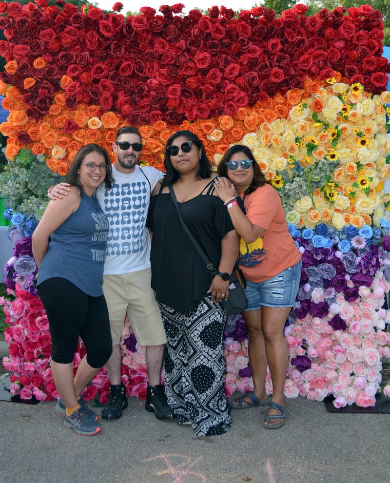 Rachel and Bill Lendman, of Dixon; Arianna Galvan, of Rock Falls; and Andrea Canas, of Dixon, pose for a photo in front of a rainbow-colored wall of flowers during the second annual Dixon Pride Fest. The free, family-friendly event took place at Page Park in Dixon on June 17, 2023.