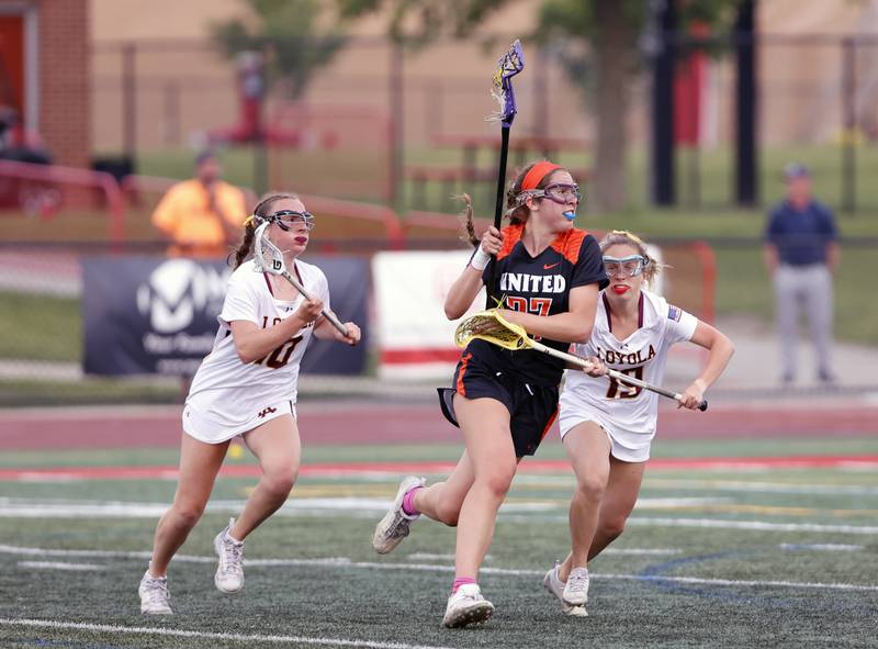 Crystal Lake Central Coop's Anna Star (27) breaks through the Loyola Academy defense during the lacrosse state semi-final match between Crystal Lake Central and Loyola Academy on Thursday, June 5, 2025 in Hinsdale.