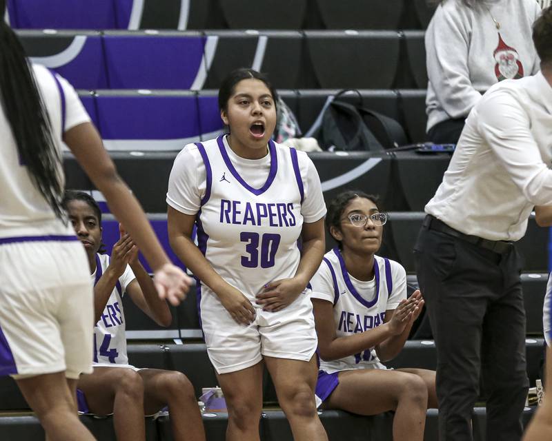 Plano's Cami Nunez (30) cheers on the team from the bench during their basketball game between Johnsburg at Plano, Monday Dec 16, 2024 in Plano.