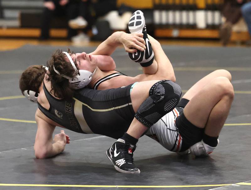 Kaneland’s Alex Gochis (top) turns Sycamore’s Jayden Dohogne during their 138 pound match Thursday, Jan. 9, 2025, at Sycamore High School.