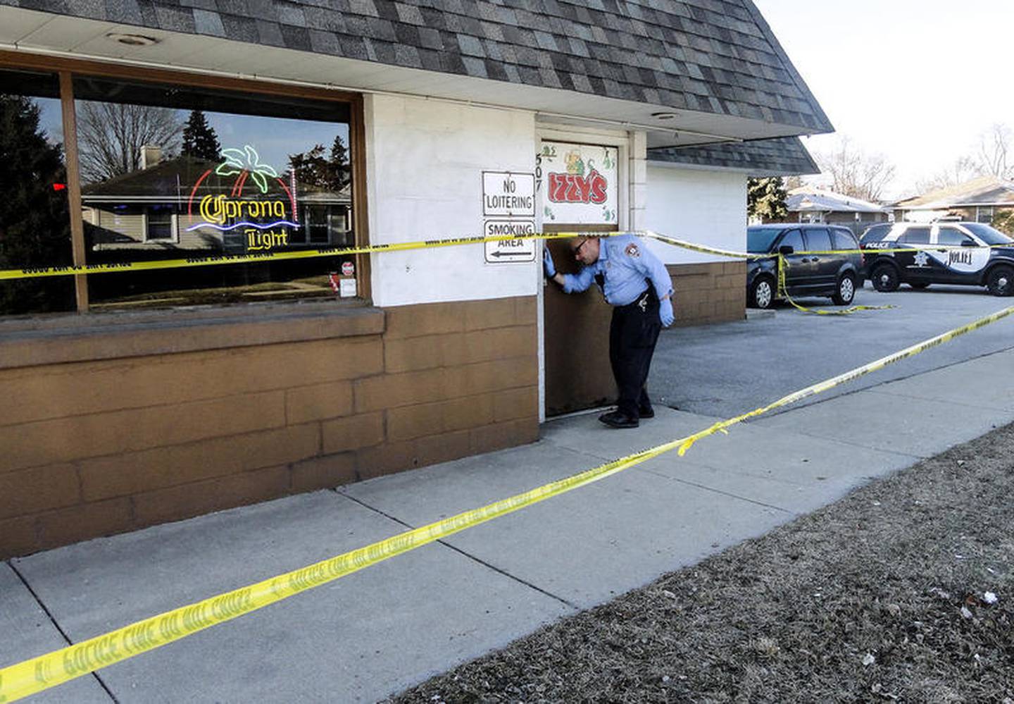 An investigator enters Izzy's Tap on Friday, March 9, 2018, after Patrick Gleason allegedly killed Daniel Rios III at 507 Theodore St., in Joliet, Ill.