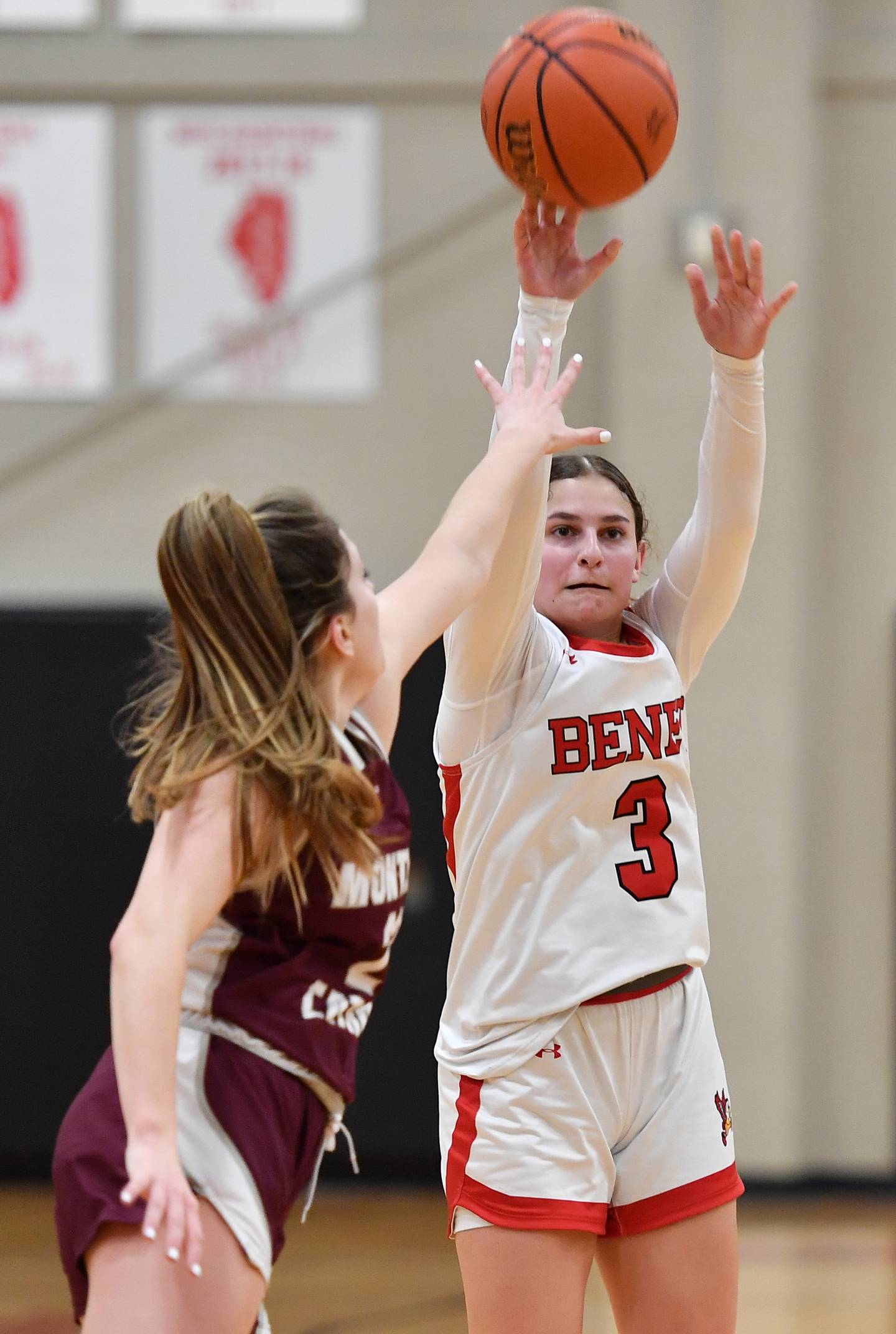 Benet's Aria Mazza (3) shoots her fourth three pointer as Montini's Shea Carver defends during a game on Feb. 5, 2024 at Benet Academy in Lisle.