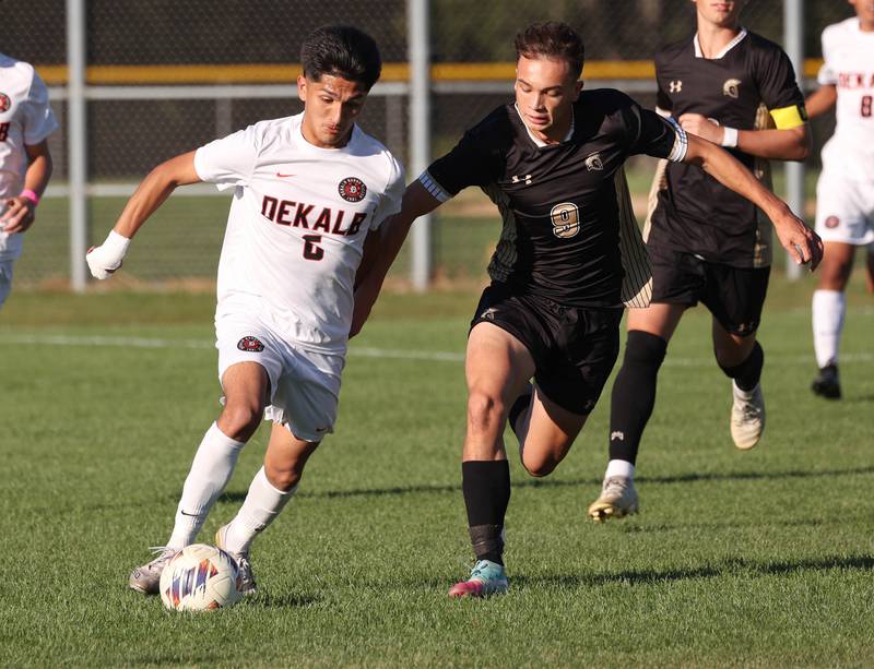 DeKalb's Mauricio Jasso pushes the ball ahead of Sycamore's Felix Arends during the El Classicorn rivalry game Tuesday, Oct. 7, 2025, at Sycamore High School.