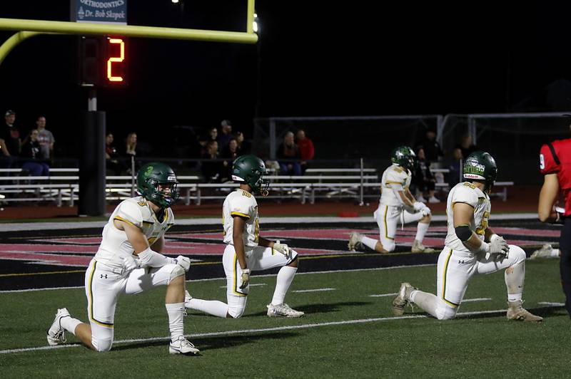 Crystal Lake South players take a knee fore their first offensive play during a Fox Valley Conference football game against Huntley on Friday, Sept. 29, 2023, at Huntley High School.